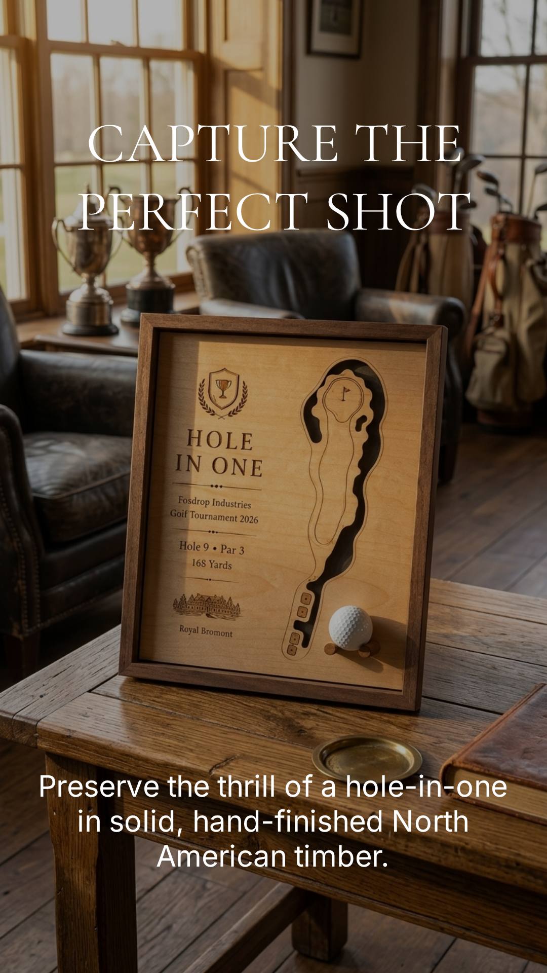 Framed etched hole-in-one golf map with a ball set into the panel, on a clubhouse table